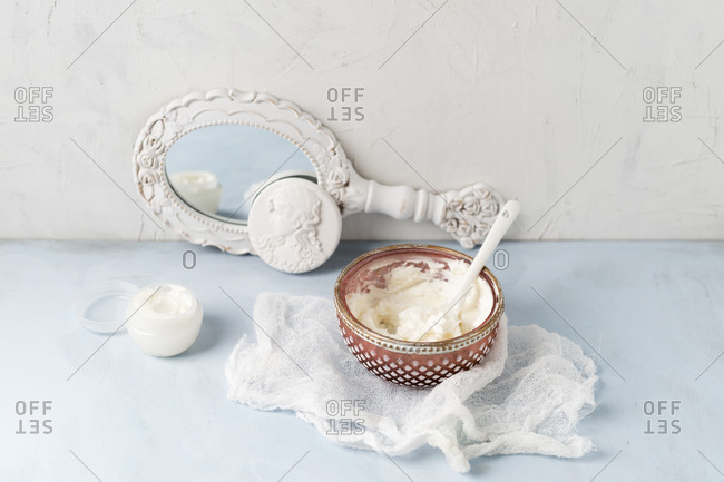 Gauze- hand mirror and bowl of homemade shea butter moisturizer