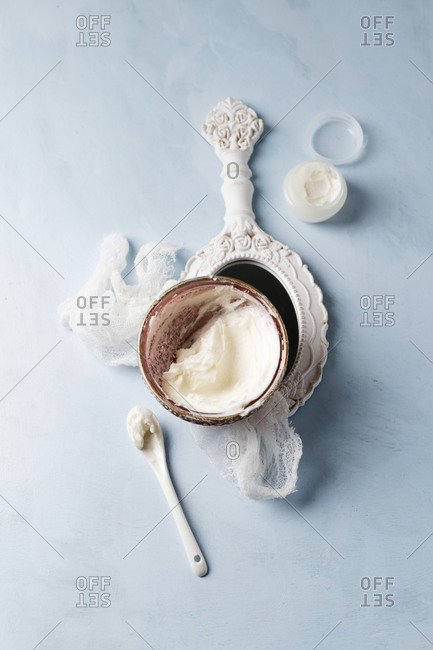 Gauze- hand mirror and bowl of homemade shea butter moisturizer