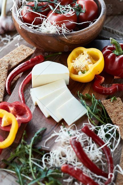 Cheese with sweet peppers, tomatoes, and arugula