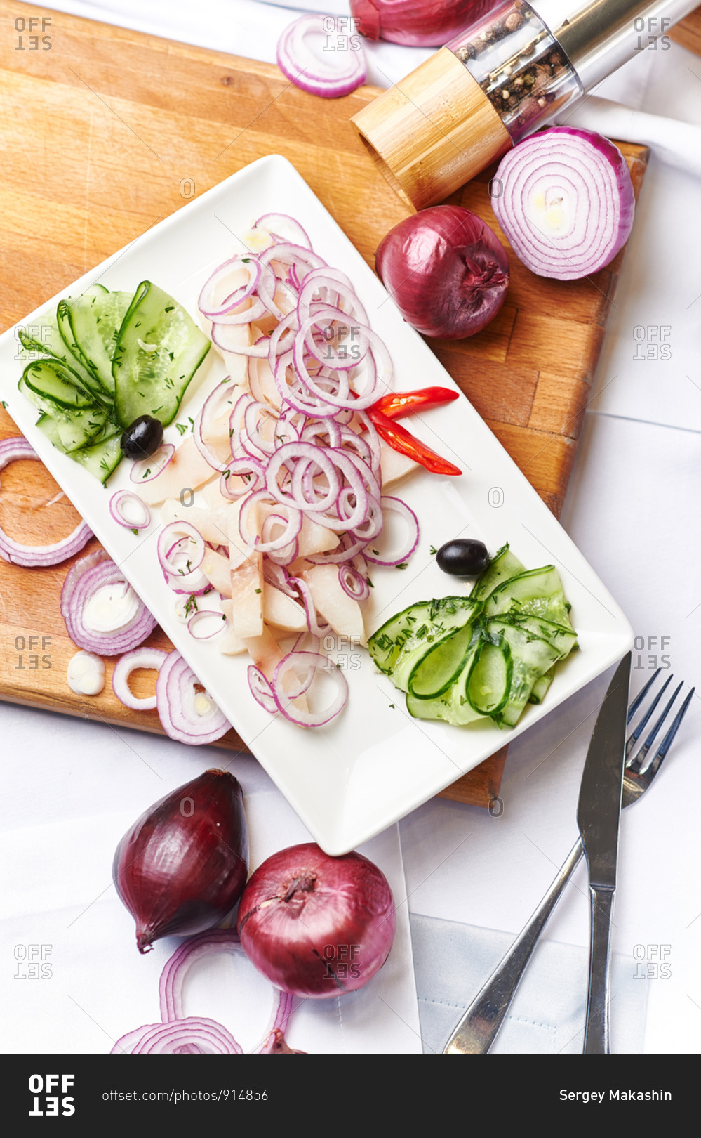 Fresh fish in a white vinegar and spices with onions pepper and cucumber