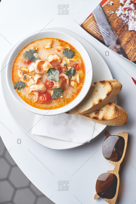 Asian tom yam kung soup with baguette toast