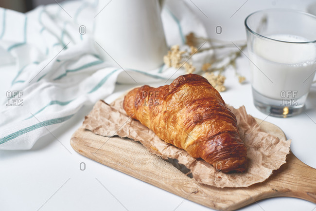 Fresh delicious French croissant made of puff pastry with country milk