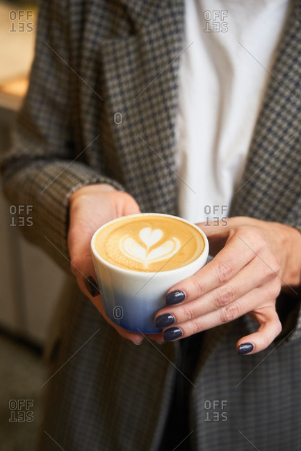 Woman's hands holding a latte