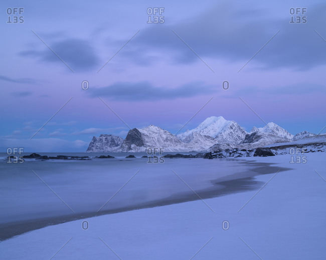 Winter twilight over snow covered Storsandnes beach, Flakstadøy, Lofoten Islands, Norway