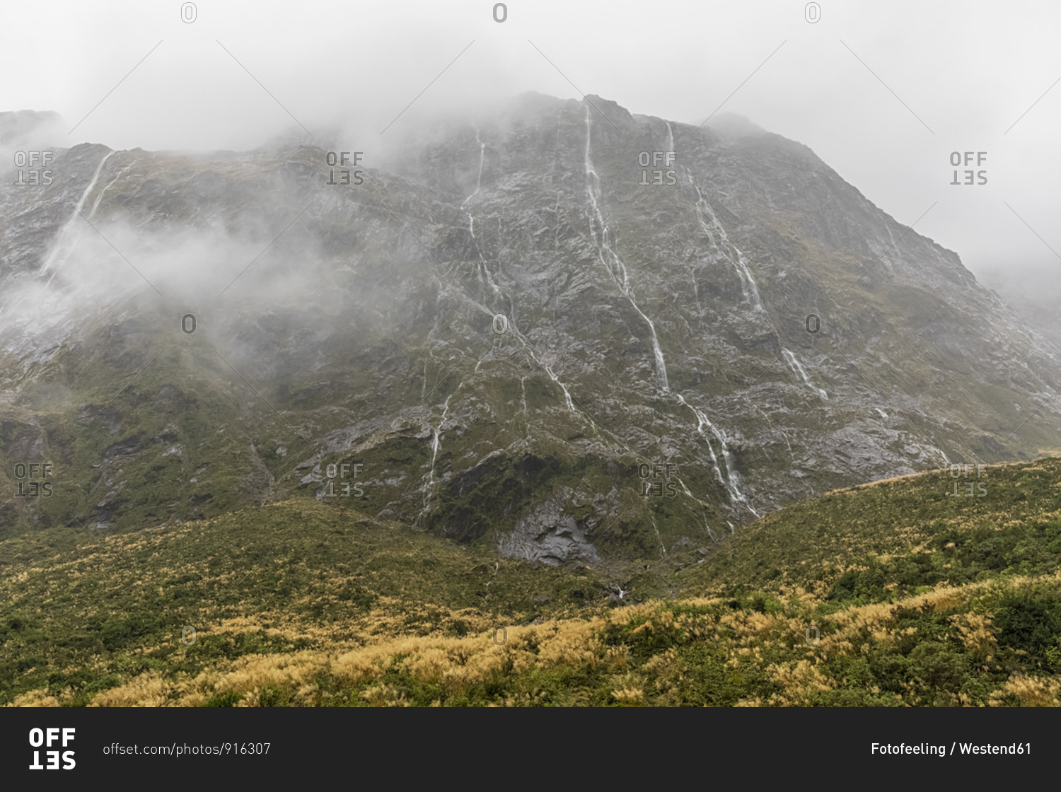 New Zealand- Oceania- South Island- Southland- Fiordland National Park- Continuous rain creating waterfalls on mountainside