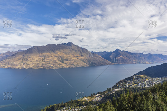 New Zealand- Otago- Queenstown- Town on shore of Lake Wakatipu with Cecil Peak and Walter Peak in background