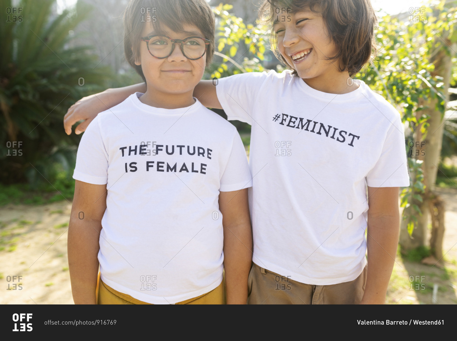 Two boys standing in the street with print on t-shirt- saying feminist and the future is female