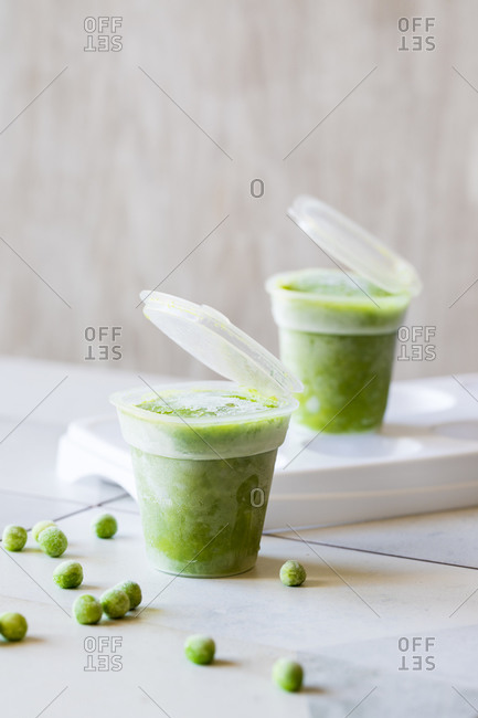 Frozen mashed peas in plastic containers