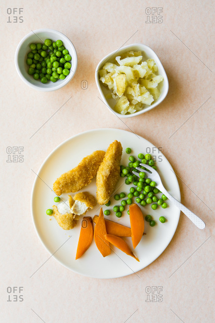 Overhead of toddler dinner with chicken and vegetables