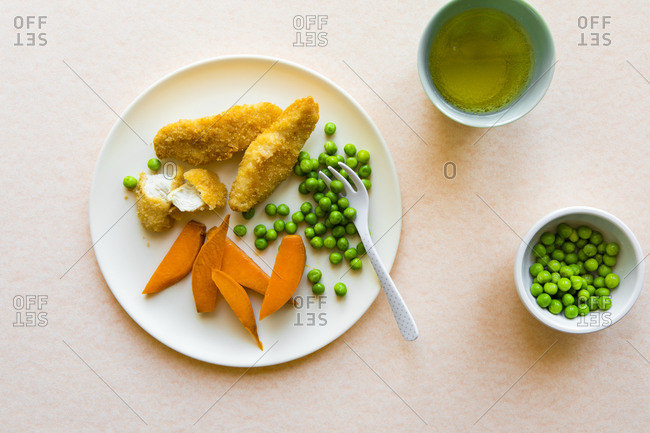 Toddler dinner with chicken, peas, and sweet potatoes