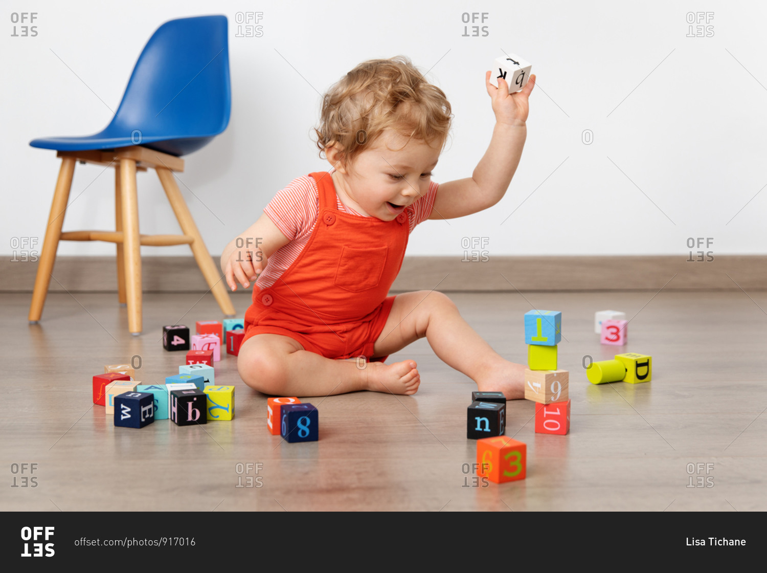 Happy baby building tower with blocks