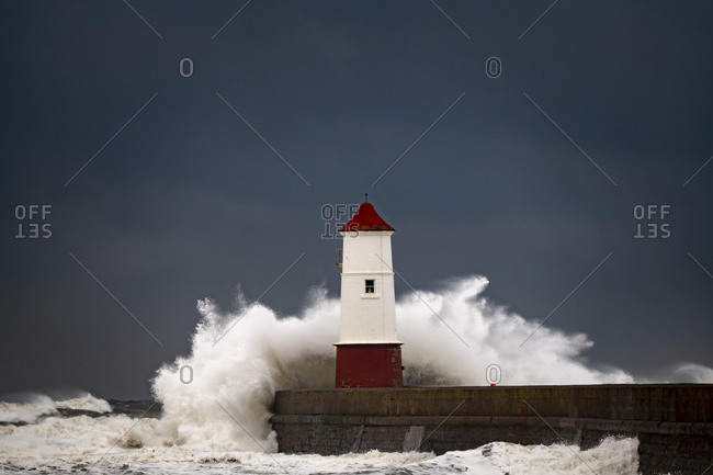 Berwick Lighthouse with strong surf and dark cloudy sky, Berwick-upon-Tweed, Newcastle upon Tyne, Northumberland, Great Britain