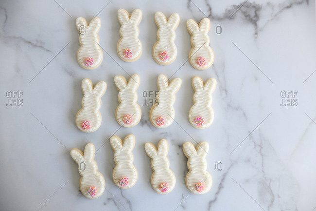 One dozen bunny rabbit Easter cookies on marble surface