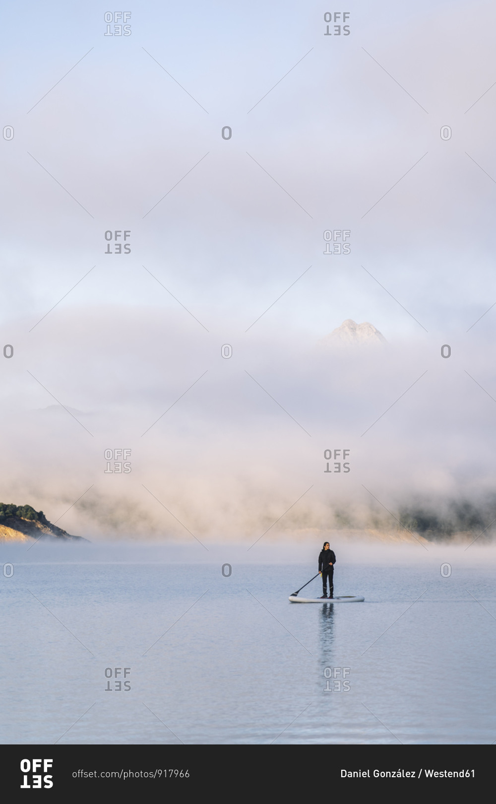 Woman stand up paddle surfing on a lake