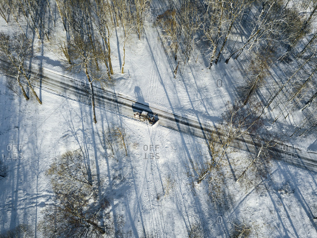 Russia- Saint Petersburg- Aerial view of snowplow clearing snow off country road