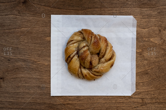 High angle close up of freshly baked cinnamon bun in an artisan bakery.