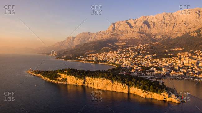 Aerial view of the sunset at the famous touristic city of Makarska in Dalmatia, Croatia. Famous Biokovo mountain is also visible.