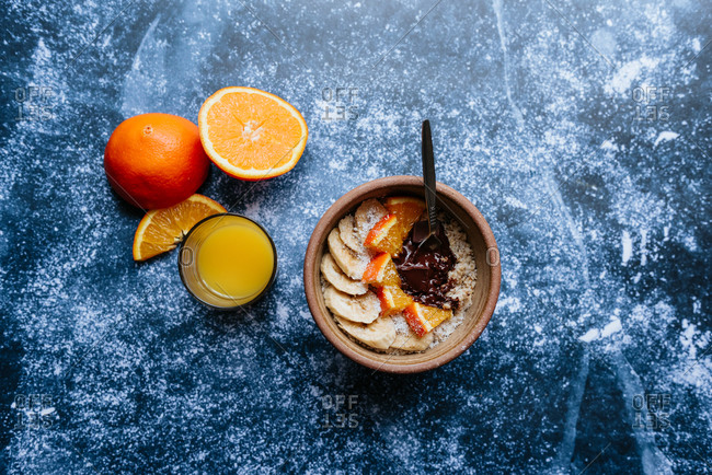 Oatmeal with chia seed, bananas and oranges served with orange juice
