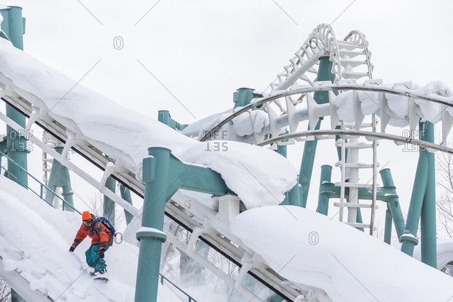 Man snowboarding on rollercoaster in Japan