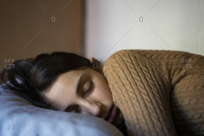 Young girl dressed in brown napping.