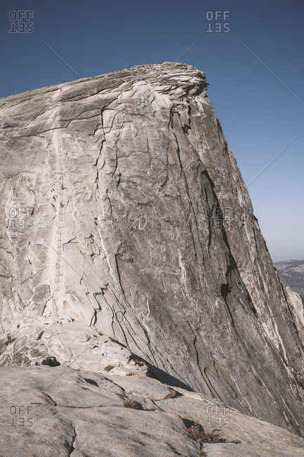 Climbers ascending cable secured section of Half Dome in Yosemite NP