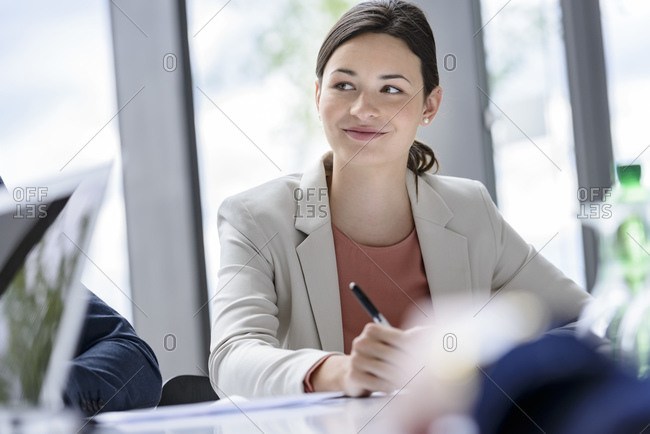 Attentive businesswoman sitting meeting- listening focused