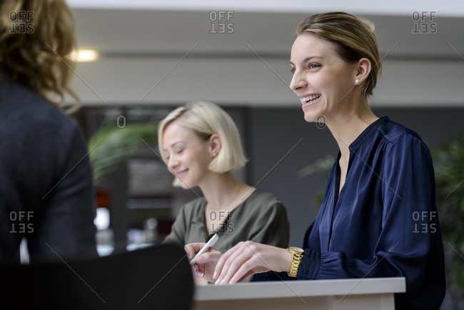 Attentive businesswomen sitting meeting- listening smiling