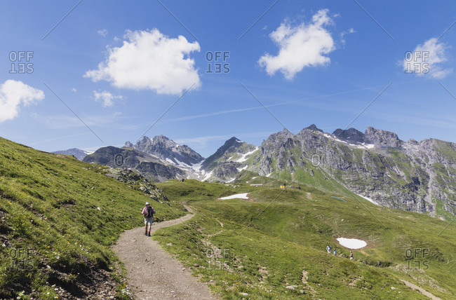 Switzerland- St Gallen Canton- Glarus Alps- Man hiking the Panoramic hiking trail in the Tectonic Arena Sardona