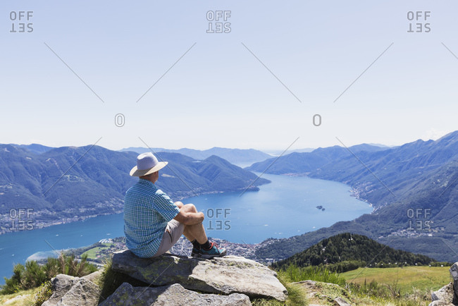 Hiker at Cimetta mountain top looking towards Lago Maggiore and Ascona- Locarno- Ticino- Switzerland