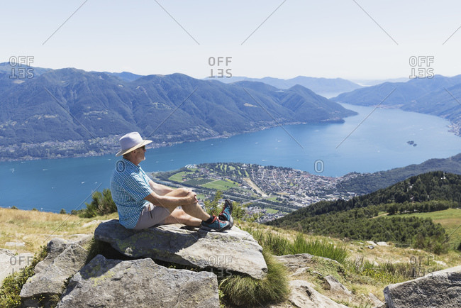 Hiker at Cimetta mountain top looking towards Lago Maggiore and Ascona- Locarno- Ticino- Switzerland