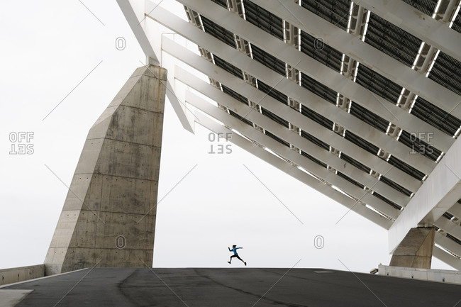 Young woman jogging at a modern building