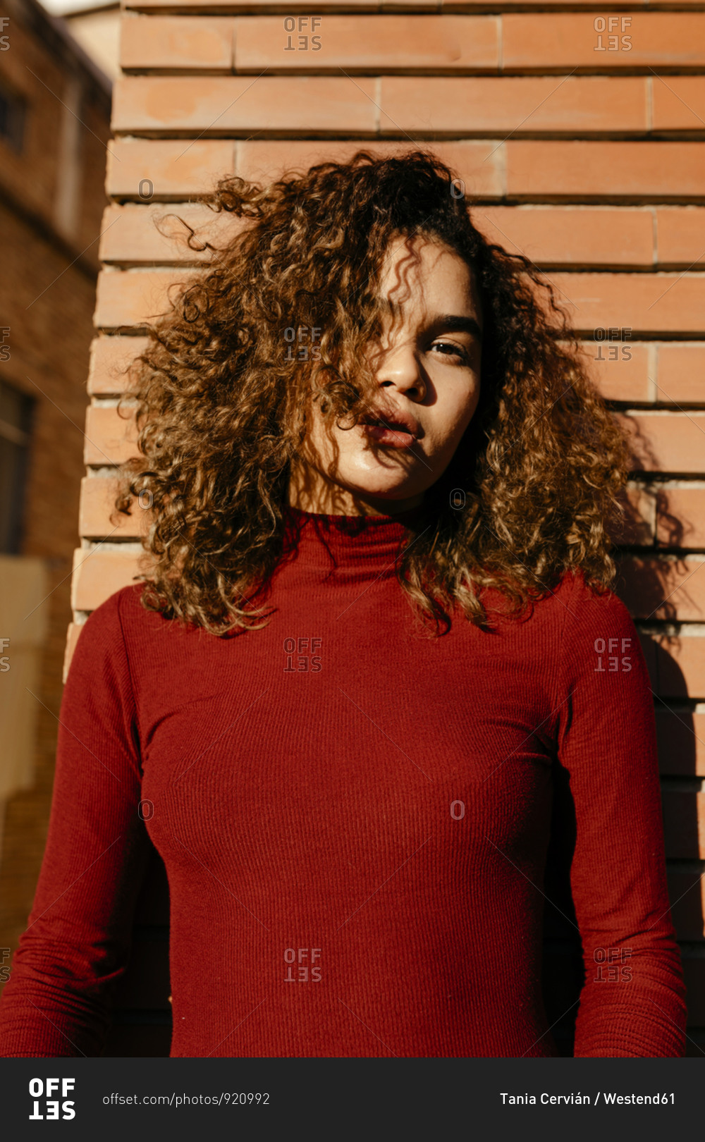 Portrait of young woman wearing red turtleneck pullover