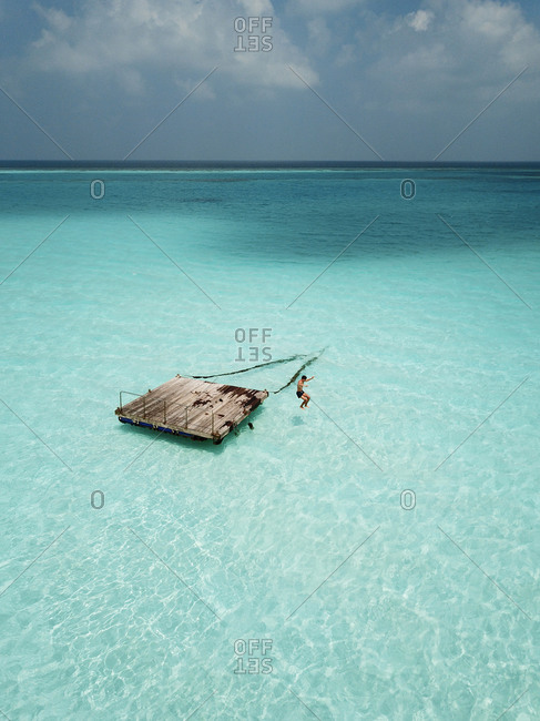 Aerial view of Pontoon in the crystal clear ocean in the Maldives, Indian Ocean