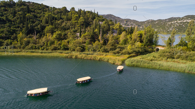 Aerial view of traditional tourist safari boats on famous tourist location Basina lakes near the city of Pole in Dalmatia, Croatia.