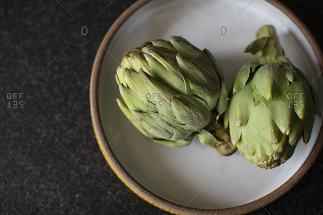 Overhead view of artichokes on a plate