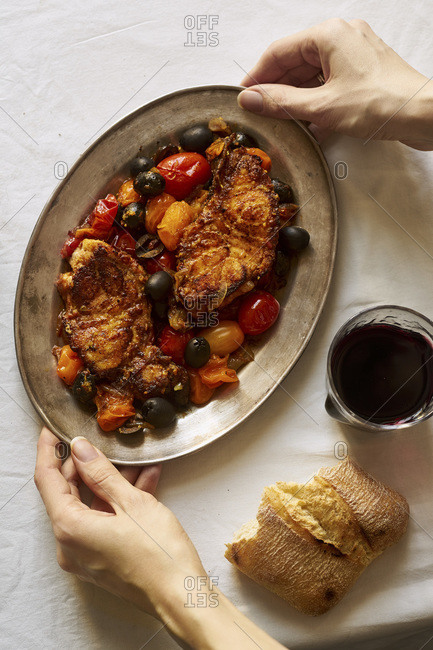 Roasted white fish with cherry tomatoes, lemon rind and olives