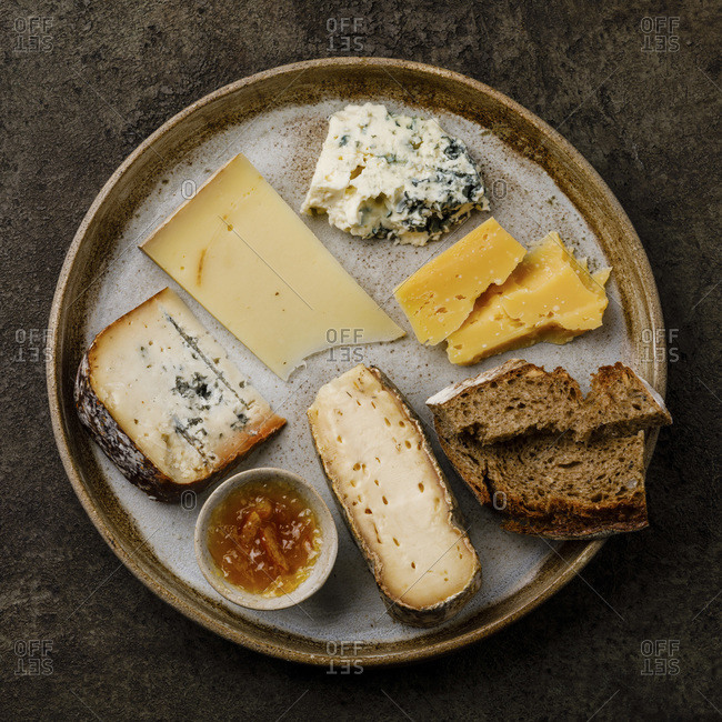 Cheese Plate with different types of cheese Snack assortment on dark background