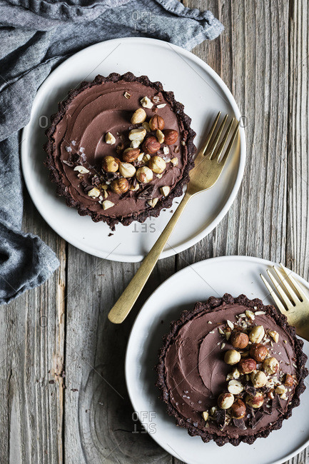 Chocolate pie with a chocolate crust base, sprinkled with hazelnuts