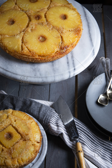 Upside down pineapple cake on a marble cake stand