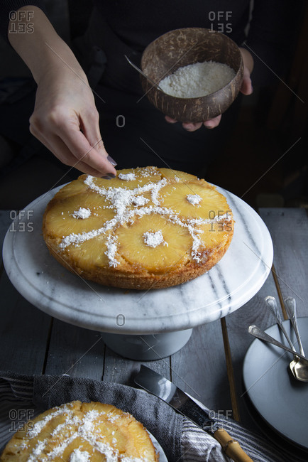 Hans decorating an upside down pineapple cake with coconut rasps