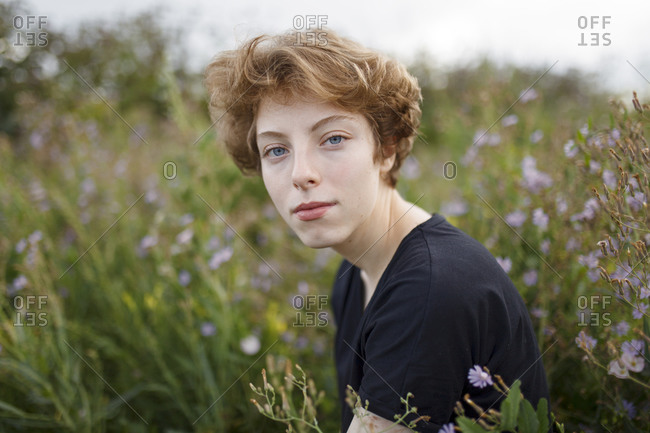 Young woman sitting in meadow