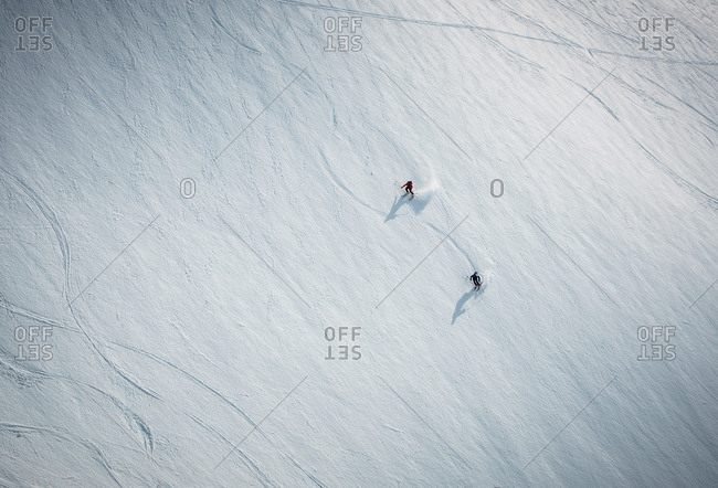 Two men skiing on snow in Iceland from overhead angle