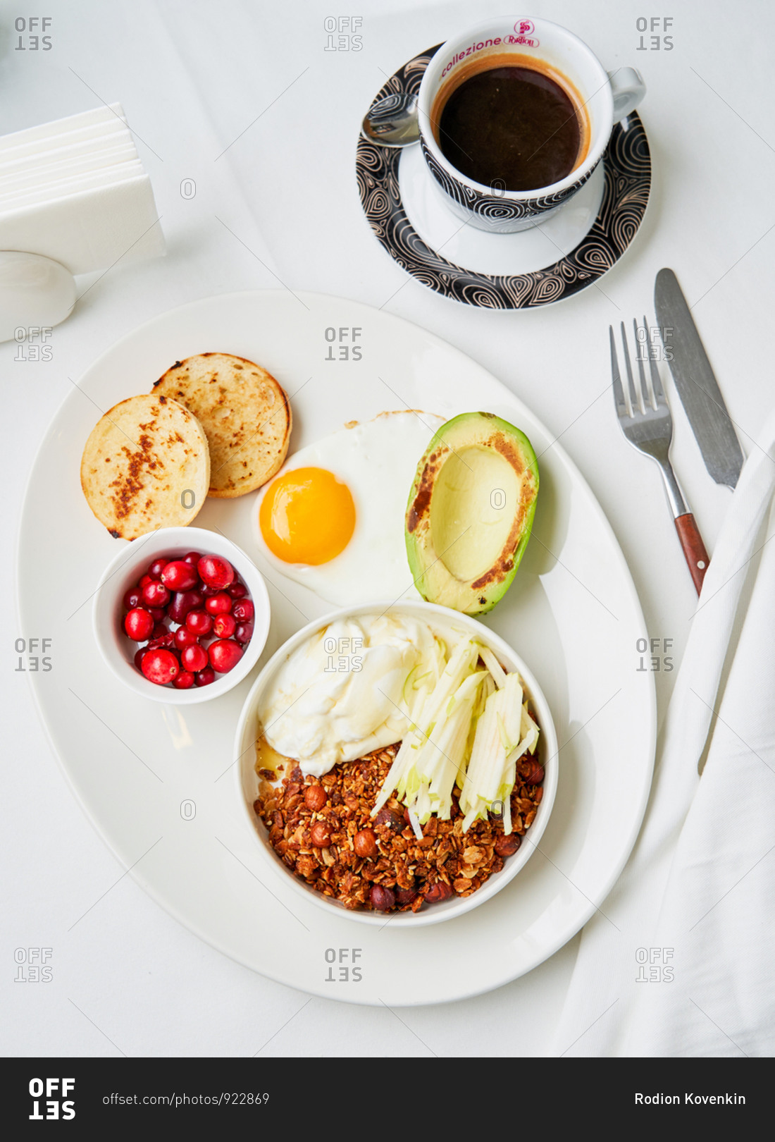 Healthy and balanced breakfast dish of homemade granola, Greek yogurt, apple, fried egg and grilled avocado