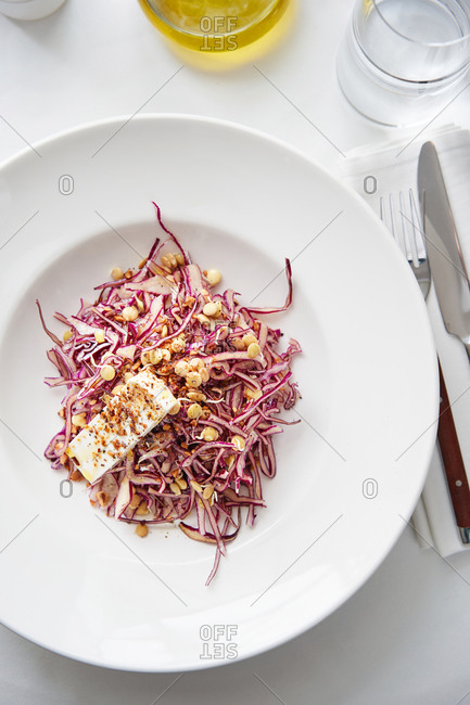 Healthy red cabbage salad with bean sprouts and feta chees on white table