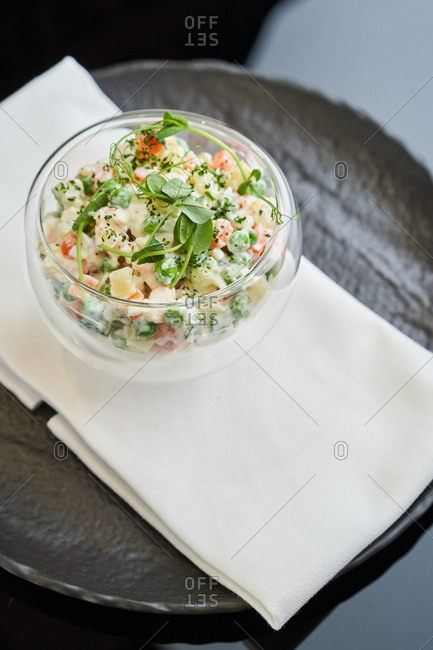 Salad 'Olivier' (famous chicken salad from Russia) served in a glass round bowl