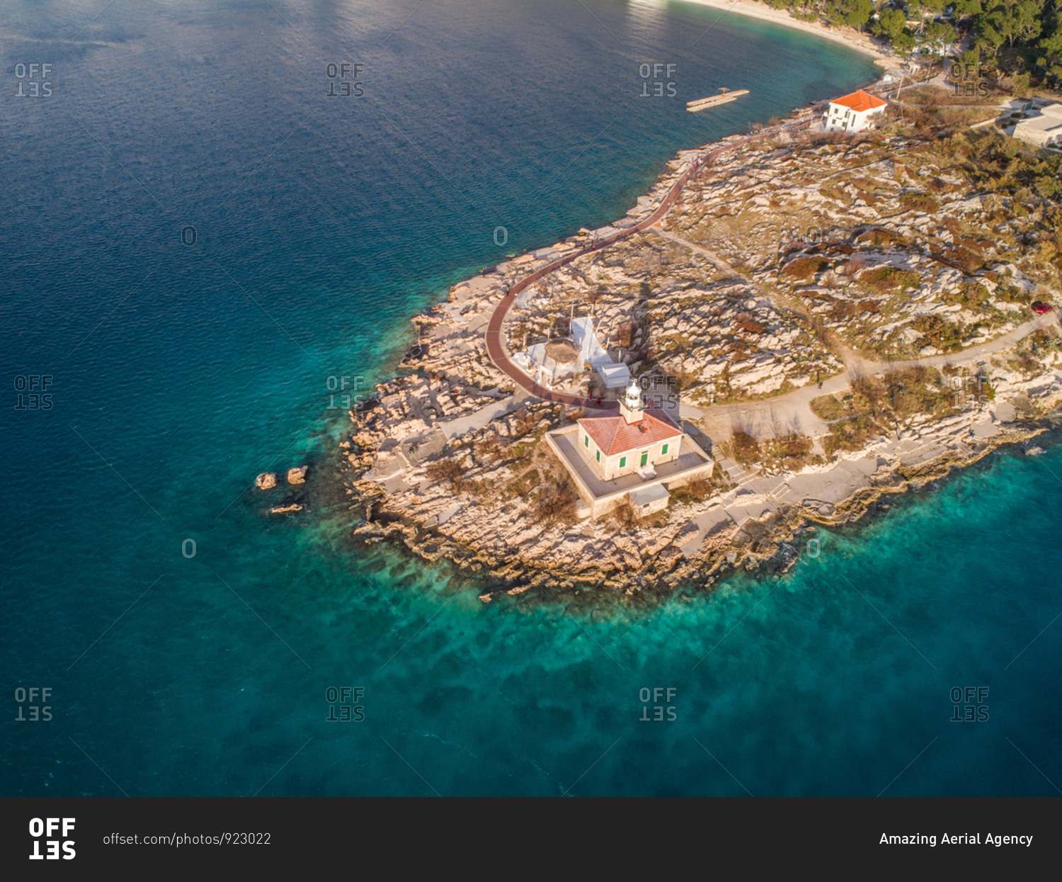 Aerial view of famous lighthouse and Adriatic sea coastline in the city of Makarska in Dalmatia, Croatia. Lighthouse is situated on the St. Peter peninsula.