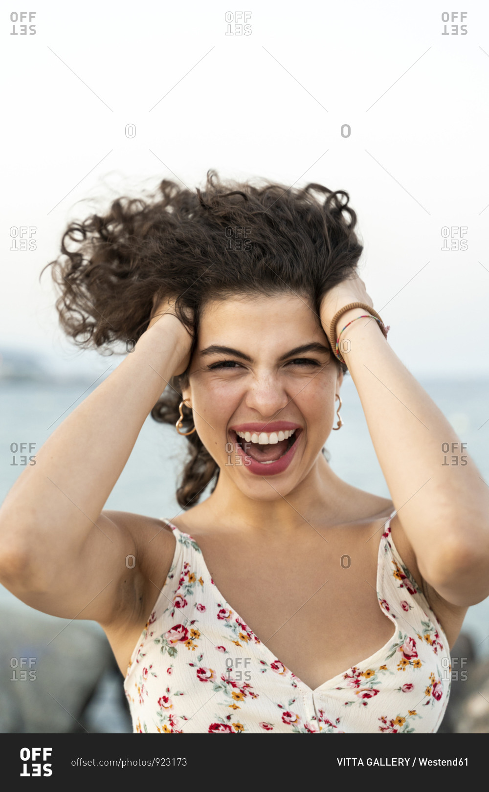 Portrait of excited young woman outdoors