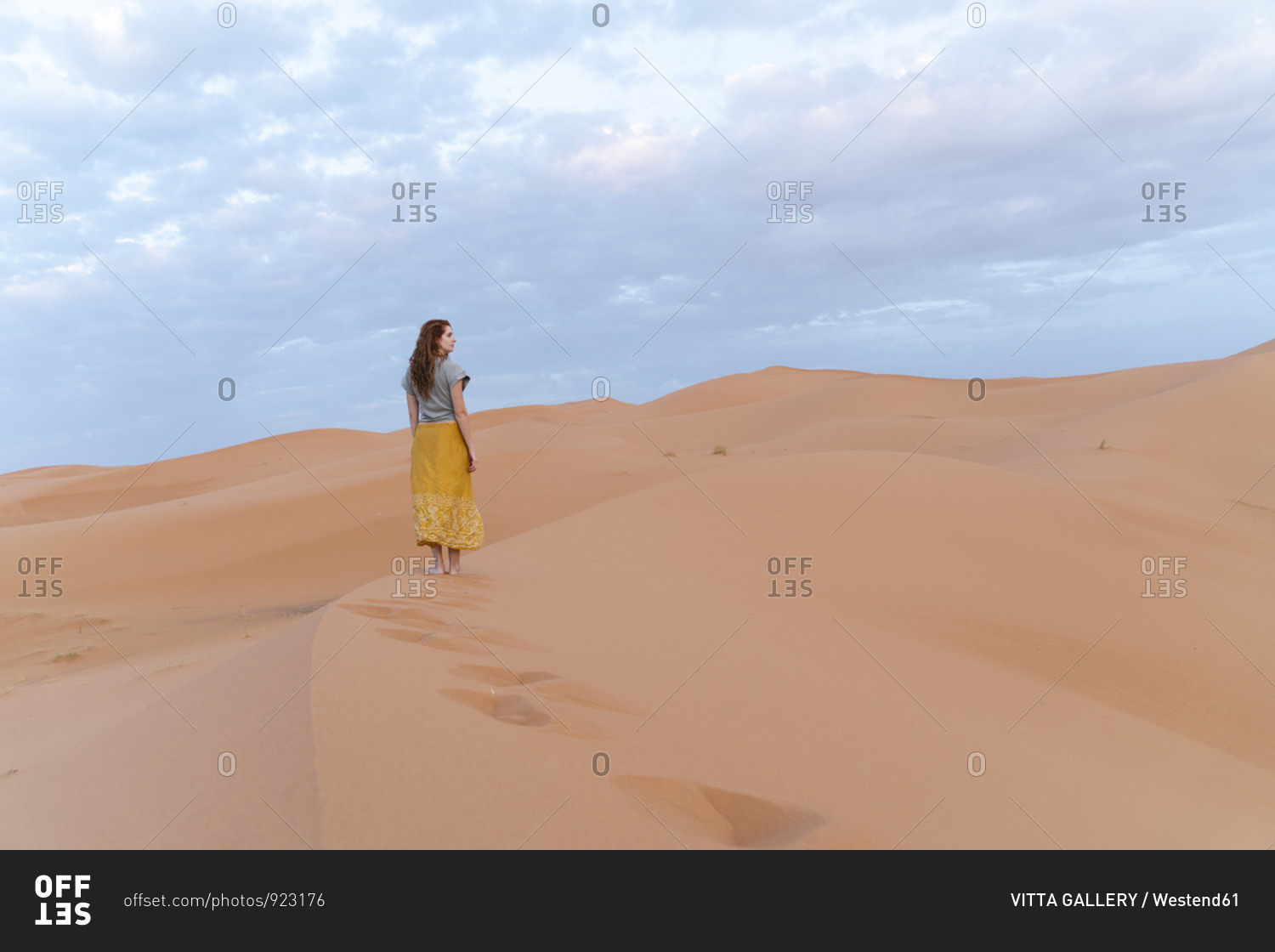 Young woman on sand dune in Sahara Desert- Merzouga- Morocco