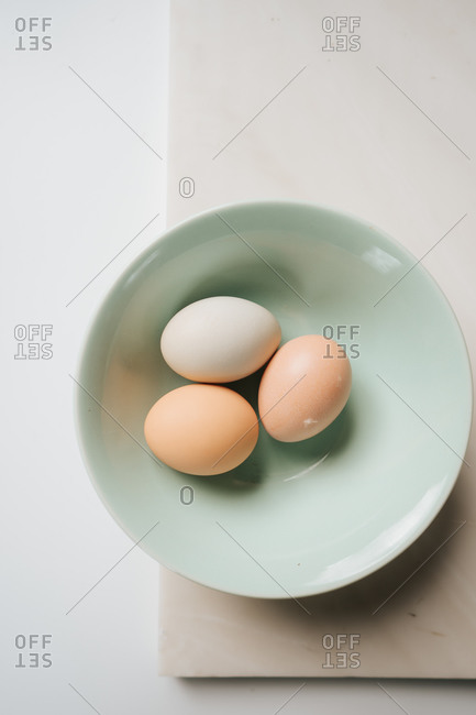 Overhead view of spring farm fresh eggs in a bowl