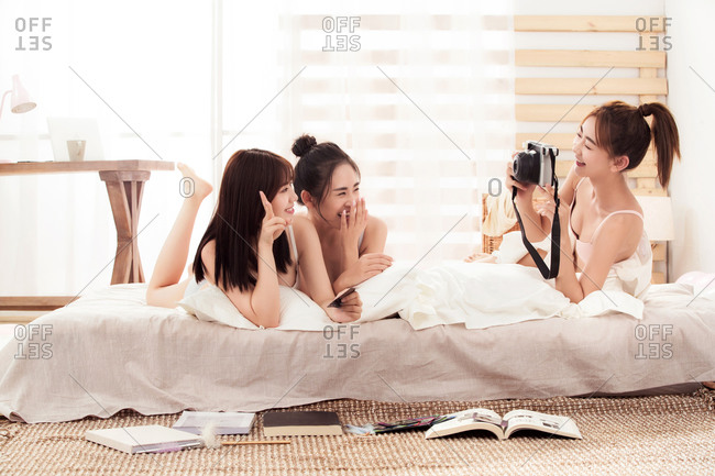 Girlfriends was lying in bed together take photos